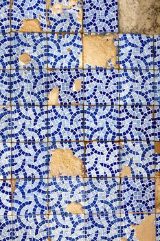 Close up view of a broken tiled wall of small azulejo.