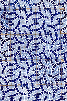 Close up view of a broken tiled wall of small azulejo.