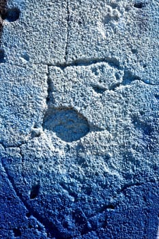 Close up view of a worn textured cement wall.