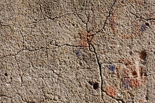 Close up view of a worn textured cement wall.