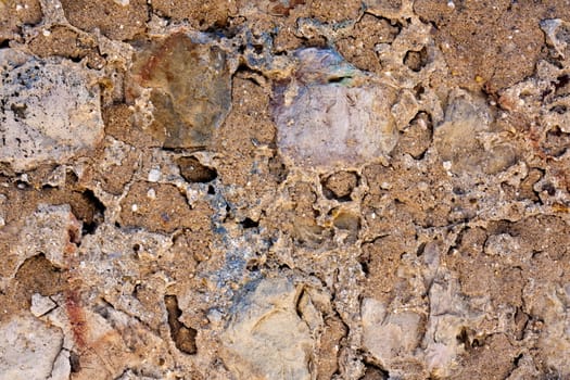 Close up view of a worn textured cement wall.