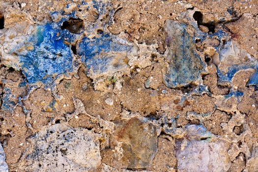 Close up view of a worn textured cement wall.