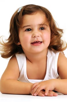 Little beautiful girl looking and smiling whilst leaning on her arms
