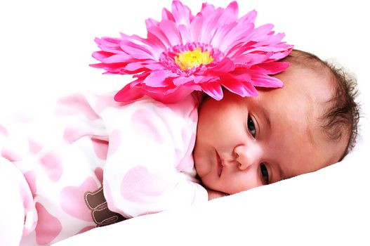 sweet newborn baby girl peaceful with a big pink flower on her