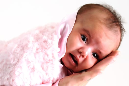 sweet newborn baby girl peaceful and wrapped in pink blanket been held by her father