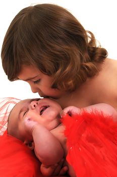 two sisters playing and smiling in studio wearing red angle wings