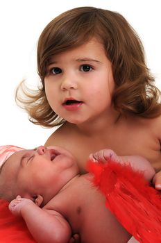 two sisters playing and smiling in studio wearing red angle wings