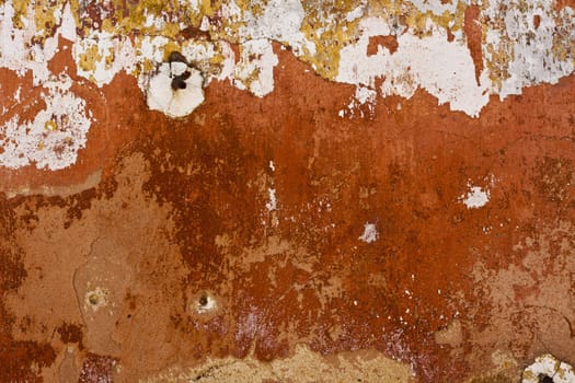 Close up view of a worn textured cement wall.