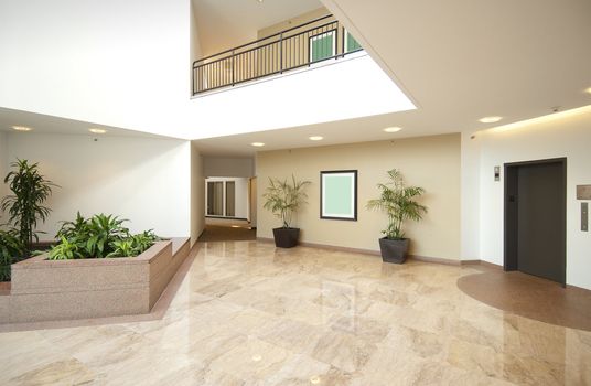 office building lobby in white and beige with marble floors