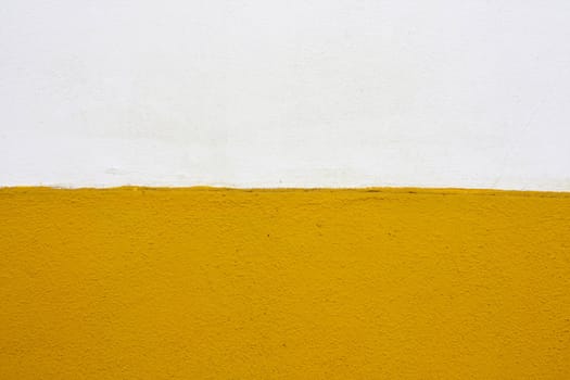 Close up view of a white and yellow wall texture.