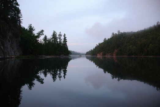 Fisherman on a lake at sunset