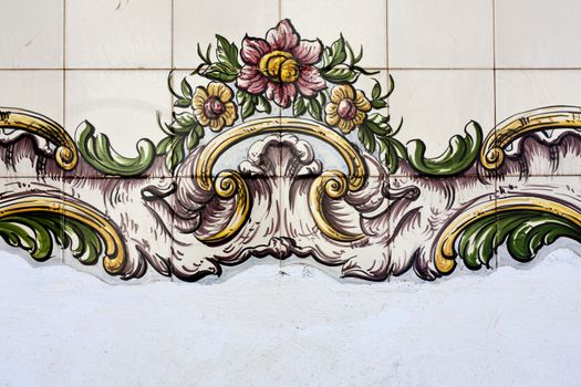 Close up view of a floral design on a tiled azulejo wall.