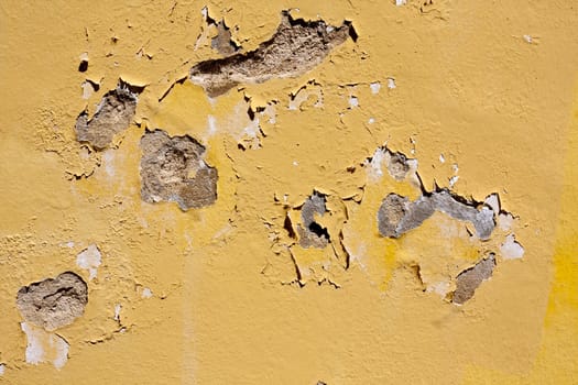 Close up view of a worn textured cement wall.