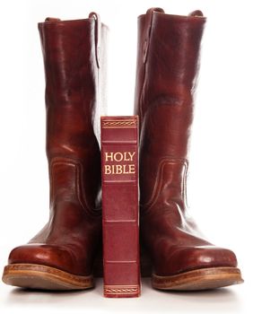 Boots and the bible against white background 