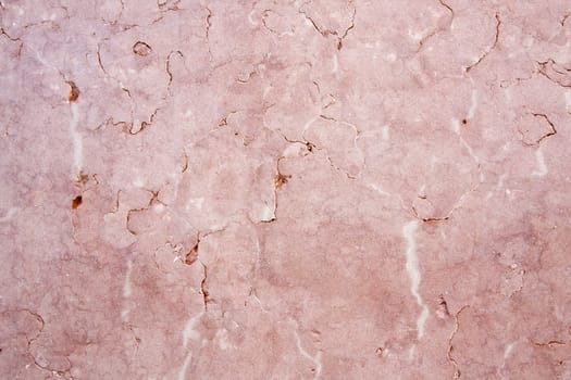 Close view of a pink textured marble wall.
