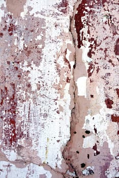 Severe paintless and cracked pink wall texture.