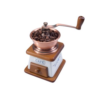 Ancient coffee grinder with coffee grains