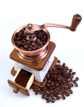 The ancient coffee grinder with coffee grains