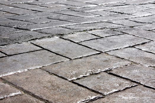 Close ground view of an dark gray urban city pavement.