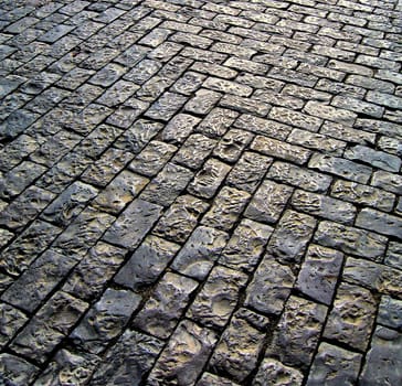 typical portuguese pavement with the glow of the sun shinning on the surface.