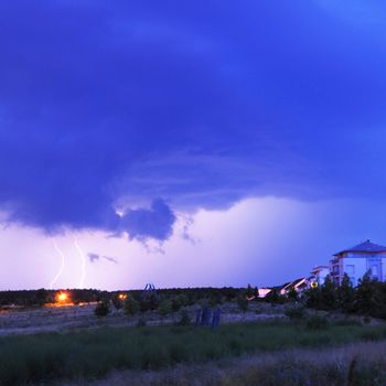 thunderstorm with lightnings and cloudy sky at rainy night