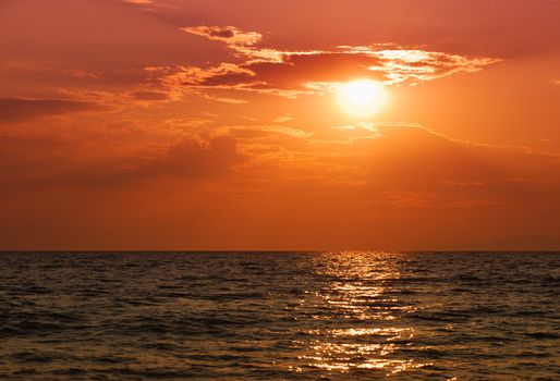 Orange sunset over Paradisos beach in Sithonia, Halkidiki, Greece.