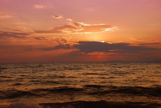 Orange and pink twilight over Paradisos beach in Sithonia, Halkidiki, Greece.