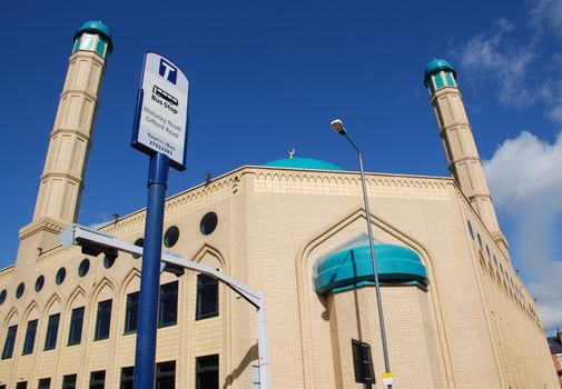 A photograph of a Mosque in Sheffield, a northern English city, next to a bus stop.