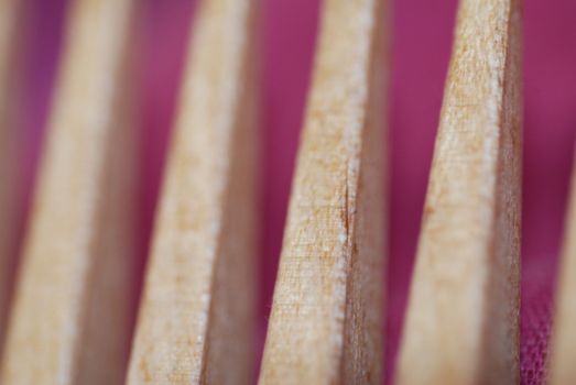 A close-up of a wooden comb, short depth of field