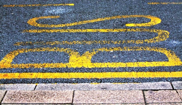 BUS painted onto road tarmac to signal a bus stop
