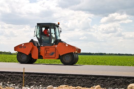 construction series: road-roller on the black asphalt