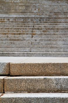 Focused near steps with many upward leading stairs in background