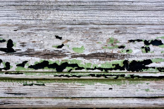 Close up view a wooden texture with peeled paint.