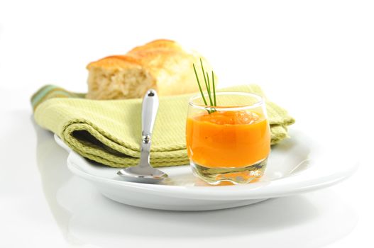 Appetizer portion of homemade squash soup with chives.