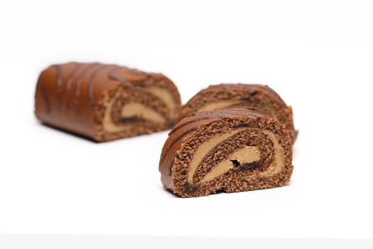 Sliced chocolate cake on white background