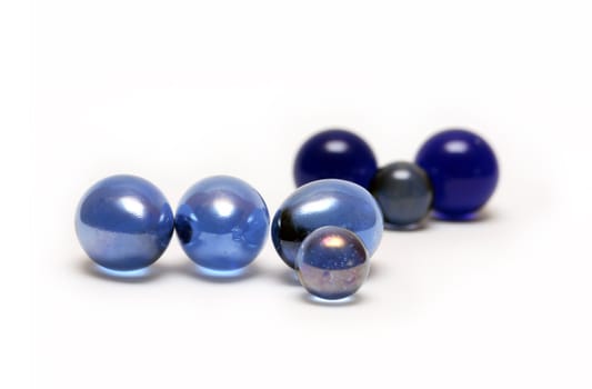 Few various blue glass balls on white background