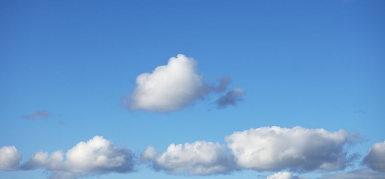 Blue summer cloudy sky - a panoramic background