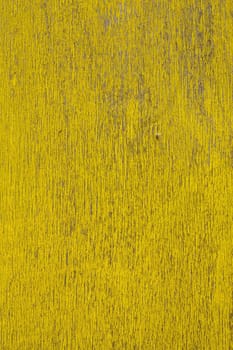 Close up view of a peeled yellow wooden textured wall.