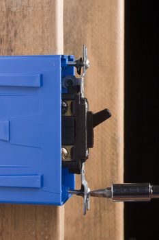 Installation of a black light switch into a switch box.