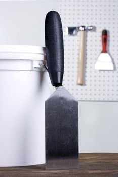 Plastering pallet next to a white bucket.