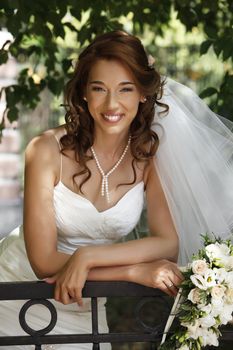 The beautiful bride on a green background