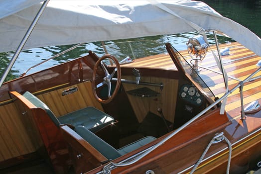 Antiwue wooden boat docked at a boat show