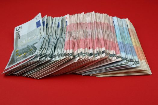 Money 5 euro on red backgraund