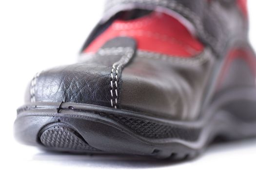 Macro view of sole of a child shoe isolated over white