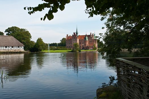 Egeskov castle slot landmark fairy tale castle in Funen Denmark view from the estate lake