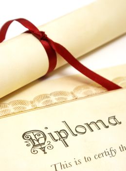 A diploma over white represents a high achieving student.