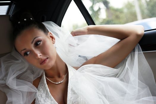 The beautiful bride in the automobile