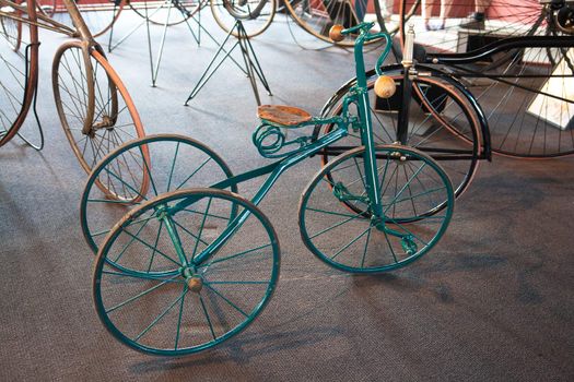 Vintage Antique Old Classical  Bicycle with three wheels and a wooden chair