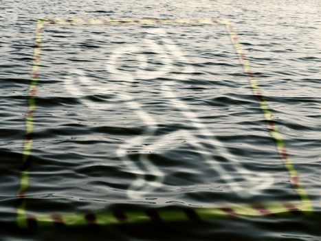 silhouette of a dead man on the water over police tape