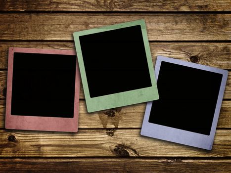 Photo of photo frames at abstract wooden background 